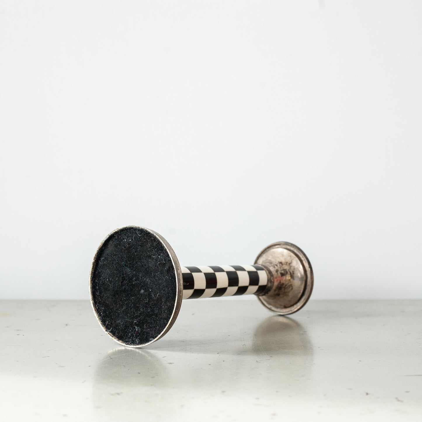 Pewter and faux ivory chequered candlestick. Mid-20th Century.