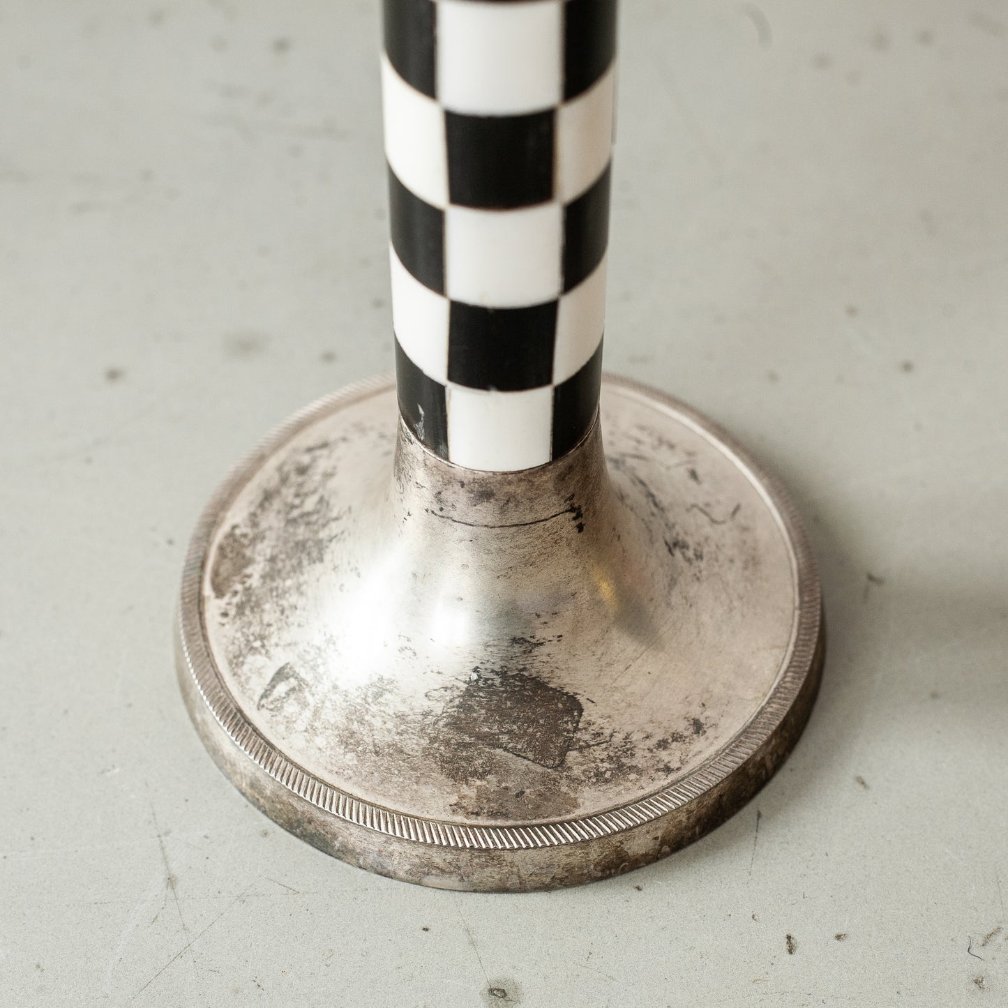 Pewter and faux ivory chequered candlestick. Mid-20th Century.