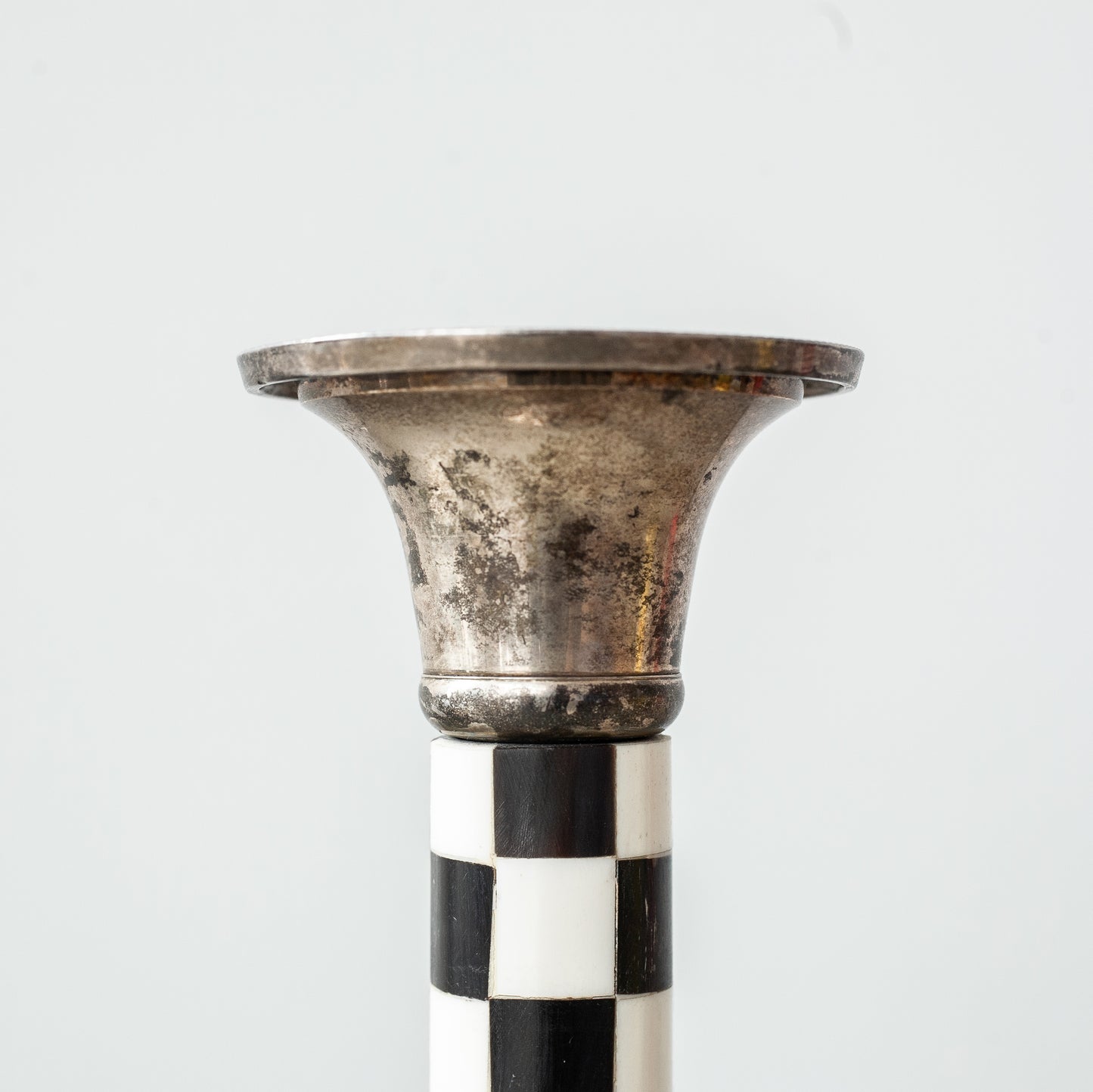 Pewter and faux ivory chequered candlestick. Mid-20th Century.
