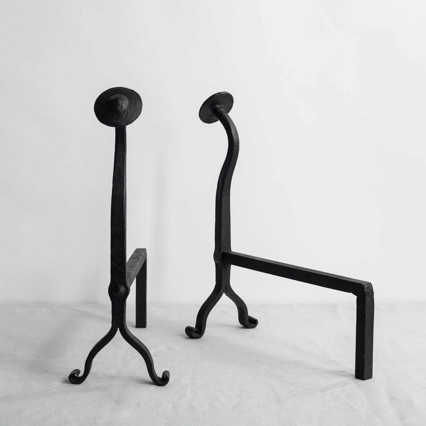 Pair of Arts and Crafts iron fire dogs, England. Early 20th Century.
