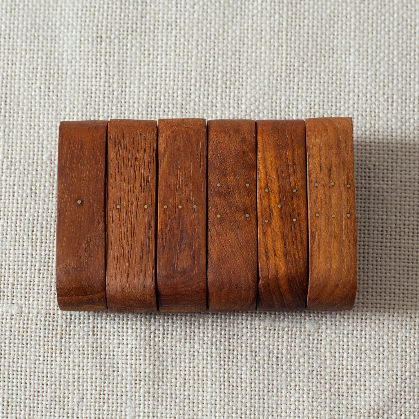 Set of six teak and brass napkin rings, Laurids Lønborg, Denmark. 1950s.