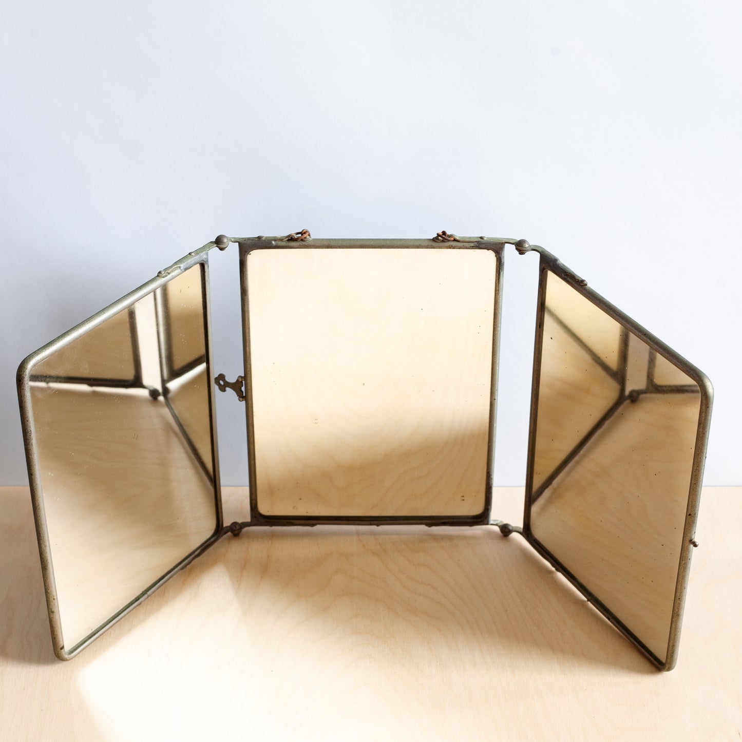 Foldable mirror with a metallic frame on a light background